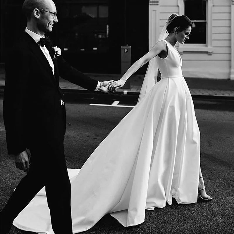 ivory wedding dress with groom Bride in Ivory Dress and Groom in Classic Black Tuxedo